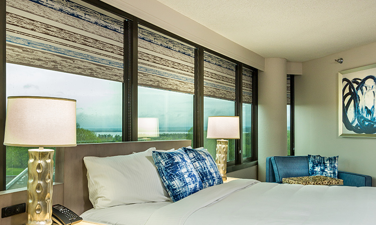 Hotel room featuring roller shades window treatments